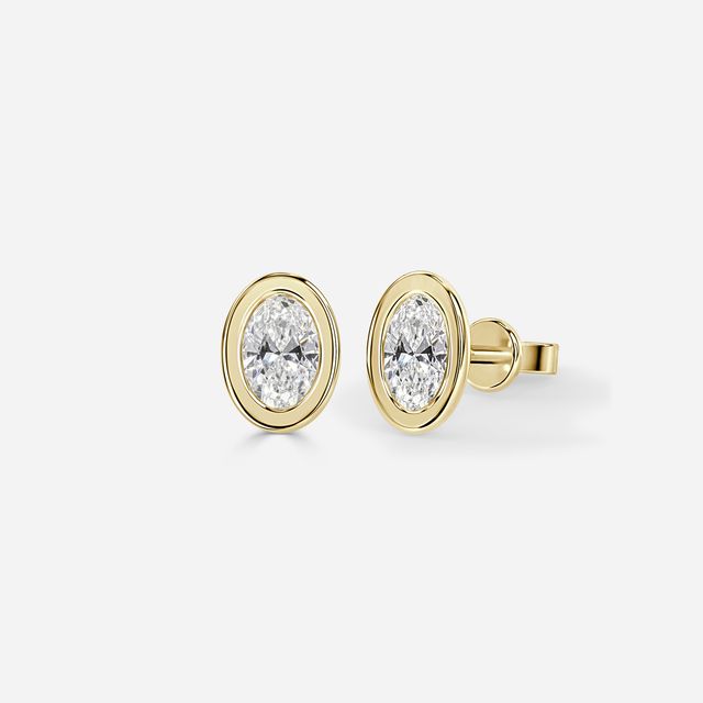 Bezel Set Oval Cut Diamond Studs In Yellow Gold