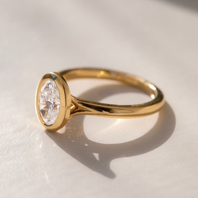 1.50 Carat Lab Grown Oval Bezel Engagement Ring In Yellow Gold – London