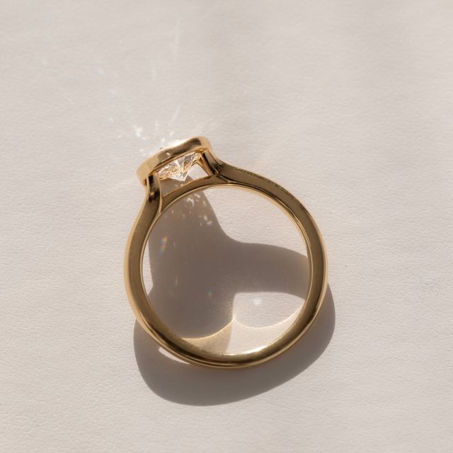 1.50 Carat Lab Grown Oval Bezel Engagement Ring In Yellow Gold – London