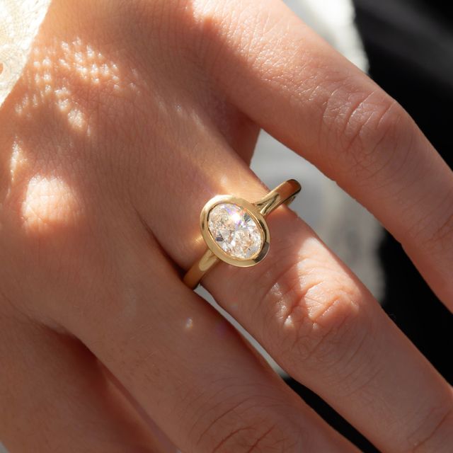 1.50 Carat Lab Grown Oval Bezel Engagement Ring In Yellow Gold – London