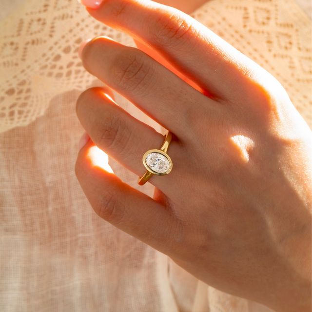 1.50 Carat Lab Grown Oval Bezel Engagement Ring In Yellow Gold – London