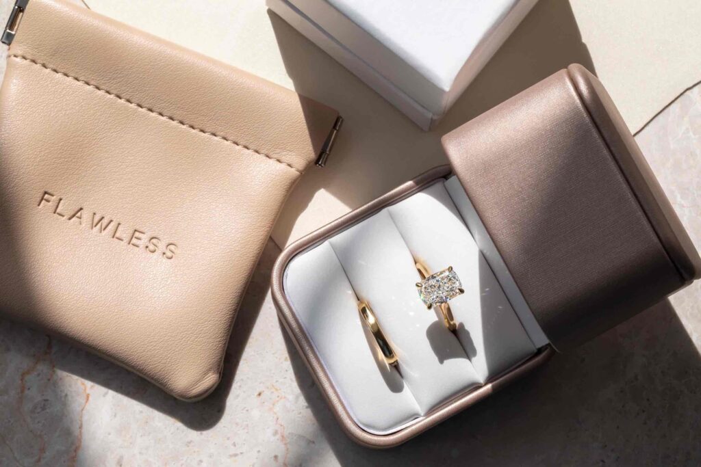 engagement ring featuring a Lab grown radiant diamond and a wedding band displayed in a ring box
