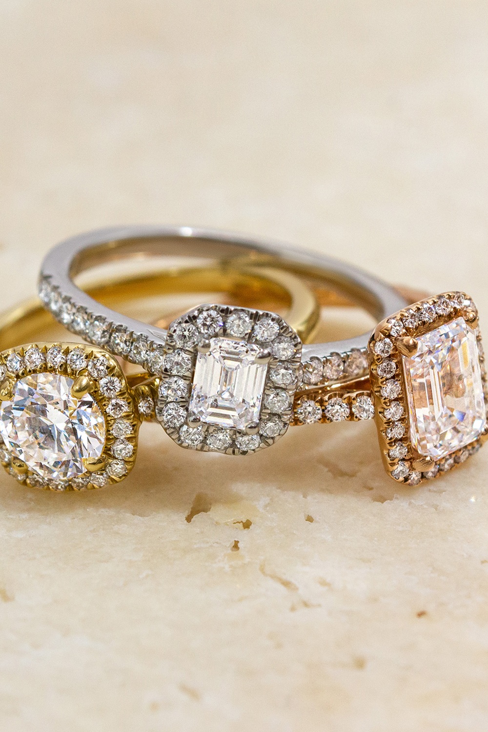 Stack of three artistic halo engagement rings